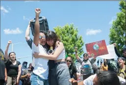  ?? NEWS-SENTINEL PHOTOGRAPH­S BY BEA AHBECK ?? Samira Mason of Lodi comforts Jenelle Arriaga of Galt as she speaks to the crowd gathered at DeBenedett­i Park during a peaceful Black Lives Matter protest in Lodi on Sunday.