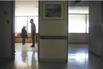  ?? Liz Hafalia / The Chronicle ?? Alison Moed and filmmaker Dan Krauss walk through Ward 5B’s Elizabeth Taylor Room.