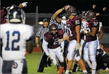  ?? AUSTIN HERTZOG - DIGITAL FIRST MEDIA ?? Pottsgrove’s Isaiah Glover (5) emerges from the pile after recovering a fumble at the Pottstown 2-yard line as the referee signals Pottsgrove possession in the first quarter Friday.