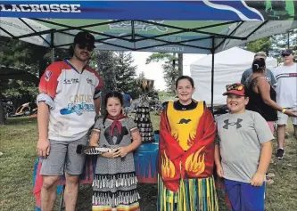  ??  ?? Peterborou­gh Century 21 Lakers' player Thomas Hoggarth shares the Mann Cup with children at the Curve Lake First Nation Pow Wow on Sunday afternoon.