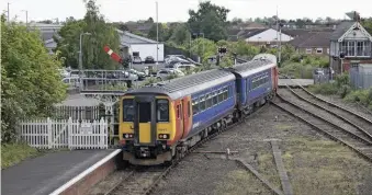  ?? NEIL PULLING. ?? The old through tracks through Boston station have been taken up, but the semaphore signal on the left and West Street Junction signal box survive from earlier times. East Midlands Trains 156410 and 153379 are on a Skegness-Nottingham service on June 1 2019.