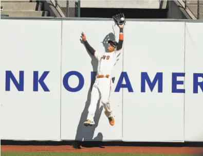  ?? Photos by Scott Strazzante / The Chronicle ?? Giants center fielder Mauricio Dubón catches a deep flyball off the bat of the Colorado’s Josh Fuentes in the fifth inning during a game at Oracle Park on Sept. 24. Dubón started 31 of the Giants’ final 37 games in center.