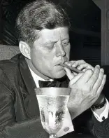 ??  ?? Lighting up: JFK enjoys a cigar