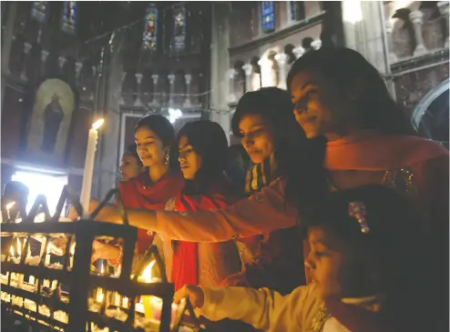  ?? ARIF ALI / AFP / GETTY IMAGES FILES ?? Pakistani Christians attend prayers at the Sacred Heart Cathedral Church in Lahore. Christians and other religious minorities in Pakistan, especially women and girls, face persecutio­n in the largely Muslim state.