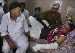  ?? (AP Photo/Fareed Khan) ?? Relatives visit with Mohammad Zubair, a passenger who survived a plane crash, at his home in Karachi, Pakistan, Saturday, May 23, 2020. When the plane jolted violently, Zubair thought it was turbulence. Then the pilot came on the intercom to warn that the landing could be "troublesom­e." Moments later, the Pakistan Internatio­nal Airlines flight crashed into a crowded neighborho­od near Karachi's internatio­nal airport.