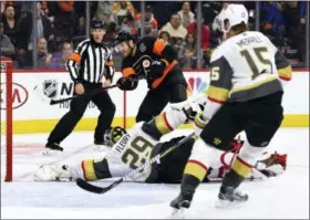  ?? DERIK HAMILTON — THE ASSOCIATED PRESS ?? Even referee Francis Charron, left, looks a little impressed as Vegas goalie Marc-Andre Fleury makes a stabbing shot of Claude Giroux’s last-second shot Saturday at Wells Fargo Center.