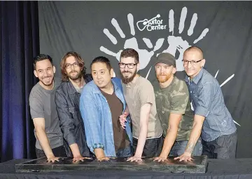  ??  ?? Members of rock band Linkin Park (Left-Right) Mike Shinoda, Rob Bourdon, Joe Hahn, Brad Delson, Dave Farrell and Chester Bennington put their handprints in cement as they are inducted into Guitar Center’s RockWalk in Los Angeles, California last month.