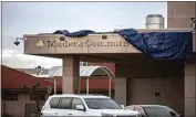  ?? ?? Outlines of the former Madera Community Hospital sign are covered by a tarp at the emergency room entrance of the hospital on Jan. 2.