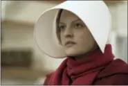  ?? GEORGE KRAYCHYK — HULU VIA AP ?? This image released by Hulu shows Elisabeth Moss as Offred in a scene from, “The Handmaid’s Tale.” Moss portrays one of the few remaining fertile women in the cruel futuristic dystopia of Gilead, a totalitari­an society where human rights are trampled...