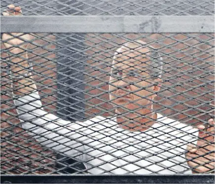  ?? Photo: REUTERS ?? Political crime: Al-Jazeera journalist Peter Greste during his 2014 trial in a court in Cairo. He had only been in Egypt for a few weeks when detained.