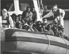  ?? ALESSANDRA TARANTINO/AP ?? MIGRANTS AND REFUGEES ENTER in the port of Roccella Jonica, Calabria region, southern Italy Nov. 14. The Italian Coast Guard rescued Sunday morning off the cost Calabria over 250 young men and boys, mostly from Egypt.