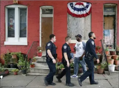  ?? PATRICK SEMANSKY — ASSOCIATED PRESS FILE PHOTO ?? In this June 23, 2016 file photo, members of the Baltimore Police Department patrol near the intersecti­on of North and Pennsylvan­ia Avenues, the site of unrest following Freddie Gray’s funeral, in Baltimore. On April 3, the Department of Justice, the...