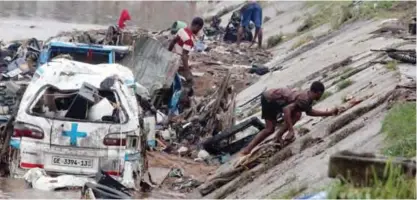  ??  ?? ACCRA: This file photo shows rescuers trying to remove valuables submerged in a flood after at least 90 people were killed in a petrol station fire in Ghana’s capital, Accra.— AFP photos