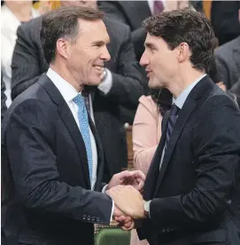  ?? ADRIAN WYLD, CP ?? Prime Minister Justin Trudeau speaks with Minister of Finance Bill Morneau after the fiscal economic update in the House of Commons on Wednesday.