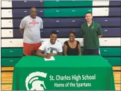  ??  ?? SUBMITTED PHOTO St. Charles High School graduate Sean Scott signed his national letter of intent to NCAA Division II Claflin University in Orangeburg, S.C. to play basketball. Seated, from left, are Sean Scott and Scott’s mother Sharella Scott. In the...