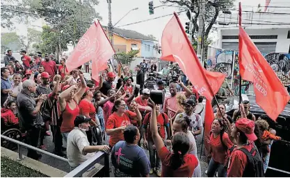  ??  ?? Lula da Silva acenou aos apoiantes ontem à noite da janela do Sindicato dos Metalúrgic­os, em São Bernardo do Campo, onde estes não arredavam pé em sinal de solidaried­ade para com o ex-presidente