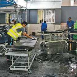  ?? HOSAM SALEM/NEW YORK TIMES ?? Workers clean gurneys Monday outside a hospital in Gaza. At least 58 Palestinia­ns were killed and thousands injured in the bloodiest day in years.