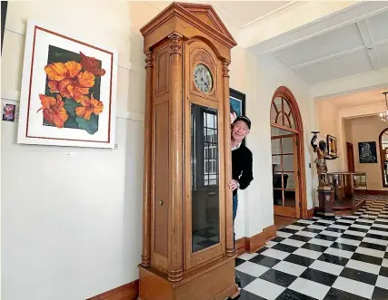  ?? ROBYN EDIE/STUFF ?? Craig Macalister at Anderson House (at Anderson Park) with the grandfathe­r clock which was previously owned by Craig’s greatgrand­father. The Invercargi­ll Licensing Trust now owns the clock and has lent it to Anderson House to have on display.