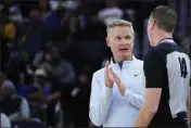  ?? GODOFREDO A. VÁSQUEZ — THE ASSOCIATED PRESS ?? Golden State Warriors coach Steve Kerr talks to referee Ed Malloy (14) after a foul was called on center James Wiseman during the first half of the team’s preseason game against the Portland Trail Blazers in San Francisco on Tuesday, Oct. 11.