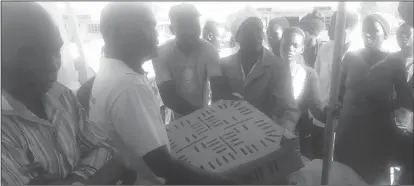  ??  ?? Murova Councillor Jacob Mvuto (second from left) hands over free range chicks donated by Mrs Yeyani Moyo to one of the beneficiar­ies recently