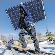  ?? Irfan Khan Los Angeles Times ?? SUNRUN employee Alejandro DeLeon helps install a solar panel on a home in Van Nuys in 2016.