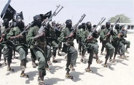  ?? FARAH ABDI WARSAMEH/FILE ?? A 2011 file photo shows hundreds of newly trained al-Shabab fighters performing military exercises in the Lafofe area some 18 kilometres south of Mogadishu, in Somalia. Abdulahi Sharif has told his partner that he was held captive twice by the extremist group.