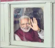  ?? PTI ?? PM Narendra Modi waves from a train at Pietermari­tzburg railway station in South Africa on Saturday. PM’s ride commemorat­ed the 1893 incident in which Mahatma Gandhi was thrown out of the first-class carriage because of his colour and race. The PM said...