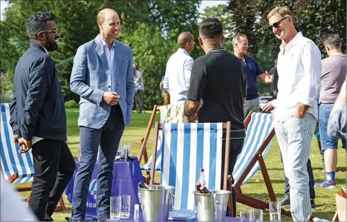  ?? Pictures: TIM MERRY; YUI MOK/PA ?? GATHERING: William, below right, and above hosts the cup final screening with Romesh Ranganatha­n (left) and Tony Adams (right). Below left, fans at Box Park