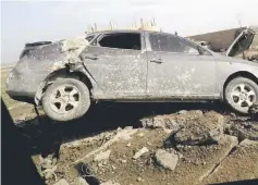  ?? — AFP photo ?? A damaged car seen during an operation.