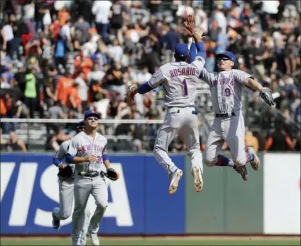  ?? JEFF CHIU — THE ASSOCIATED PRESS ?? New York Mets’ Amed Rosario (1) and Brandon Nimmo (9) celebrate after the Mets beat the San Francisco Giants in a baseball game in San Francisco, Sunday. The Mets won 4-1.