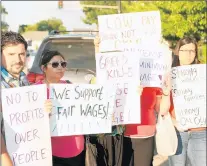  ?? ZAK KOESKE/DAILY SOUTHTOWN ?? Minimum wage advocates protest outside Calumet City’s City Hall last year after the council voted to opt out of Cook County’s minimum wage ordinance. In November, voters will be asked if their community should match the $13-per-hour Cook County minimum wage law for adults over 18.