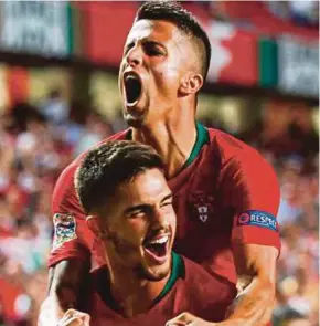  ?? EPA PIC ?? Portugal goalscorer Andre Silva (front) celebrates with teammate Joao Cancelo on Monday. Portugal won 1-0.