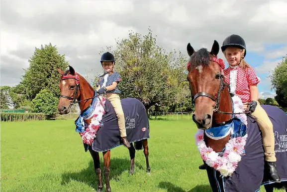  ??  ?? Sisters Imogen and Amelia are proud as punch after their success at Horse of the Year in Hastings. With the help of their trusty steeds Mia and Kingston, they came away with several wins and placings from the prestigiou­s event. Read the full story on...