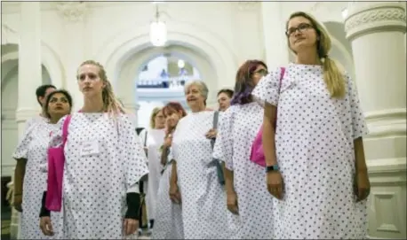  ?? ASSOCIATED PRESS ?? Planned Parenthood supporters, dressed in hospital gowns, gather outside of the Texas governor’s office at the State Capitol on July 26 during a demonstrat­ion against legislatio­n that would negatively impact Planned Parenthood.