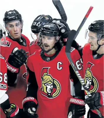  ?? FRED CHARTRAND/THE CANADIAN PRESS ?? Ottawa Senators defenceman Erik Karlsson celebrates a goal with teammates on Saturday. Karlsson and the Sens landed in Stockholm, Sweden, Tuesday morning and got right to work. The Senators play the Colorado Avalanche in a back-to-back series starting...