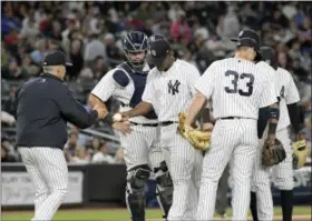  ?? BILL KOSTROUN - THE ASSOCIATED PRESS ?? New York Yankees manager Joe Girardi, left, takes the ball from New York Yankees starting pitcher Luis Severino as he leaves the game during the seventh inning of a baseball game Monday, at Yankee Stadium in New York.