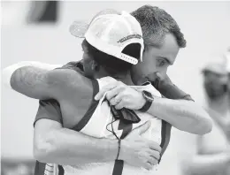  ?? JOHN MUNSON/AP ?? Colgate coach Matt Langel, pictured hugging guard Jordan Burns, guides a team that ranks second in the country in scoring at 86.3 points a game.