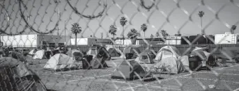  ?? ELI IMADALI/THE REPUBLIC ?? One of the two parking lots designated for a socially distanced encampment is seen during a clean-up of an encampment of people experienci­ng homelessne­ss south of downtown Phoenix during the novel coronaviru­s pandemic on April 29.