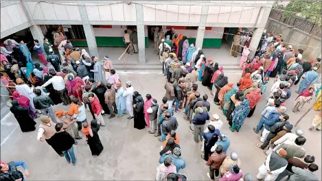  ??  ?? Indian voters queue to cast their ballot at a polling station in New Delhi on February 7. Voters went to the polls in India's capital with firebrand former chief minister Arvind Kejriwal looking to complete a surprise comeback and deliver the first...