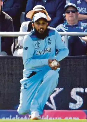  ?? AFP PIC ?? England’s Adil Rashid catches the ball to take the wicket of Sri Lanka’s Avishka Fernando for 49 runs during their World Cup match yesterday.