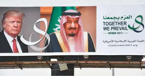  ?? AFP ?? A giant billboard bearing portraits of Donald Trump and Saudi Arabia’s King Salman on a main road in Riyadh yesterday.