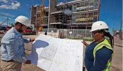  ??  ?? NEARLY DONE: Constructi­on of the Dunoon Library is under way, overseen by project manager Carl Rohrveck and project officer Phuniswa Mense.