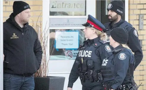  ?? TIJANA MARTIN / THE CANADIAN PRESS ?? Toronto police respond to a bomb threat at St. Michael’s College School in Toronto on Monday. Six teens have been arrested and charged in connection with an alleged sexual assault at the all-boys private school, police said.