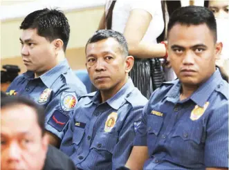  ??  ?? CONVICTED – Police officers Jerwin Cruz, Arnel Oares and Jeremias Pereda during the preliminar­y hearing of the murder complaint against them last year. On Thursday, the three were each sentenced to up to 40 years in prison with no chance of parole. (Ali Vicoy)