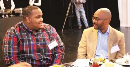  ?? | DANIEL PEREZ PHOTOS ?? Schan Parker, a senior at Wendell Phillips Academy, chats with the Rev. Chris Harris, pastor of Bright Star Church of God in Christ, at the Black History Month event.