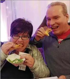  ?? FILE PHOTO ?? Marianne and Mark Kulzer sample some of the tasty grilled cheese sandwiches served up at the 2017 Melt ‘N Toast festival in Troy.