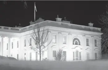  ?? PATRICK SEMANSKY/AP ?? Lights shine inside the White House on Thursday.