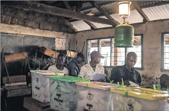  ??  ?? Popularity rules: Men cast their votes at Kiboro Primary School in Nairobi’s Mathare slum. The Internatio­nal Criminal Court charges, subsequent­ly dropped, that President Uhuru Kenyatta faced seemingly had little effect on him being returned to power....