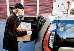  ?? EDUARDO CONTRERAS U-T ?? Zach Dinsmore, staff writer for Point Loma Nazarene University’s The Point, picks up a box of his school paper at Price Self Storage on Dec. 7 in San Diego.