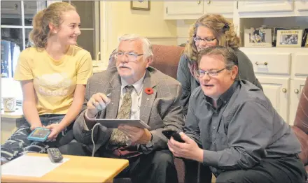  ?? COLIN MACLEAN/JOURNAL PIONEER ?? Newly elected Summerside Mayor Basil Stewart watches election results roll in with his family on Monday, Nov. 5, 2018.